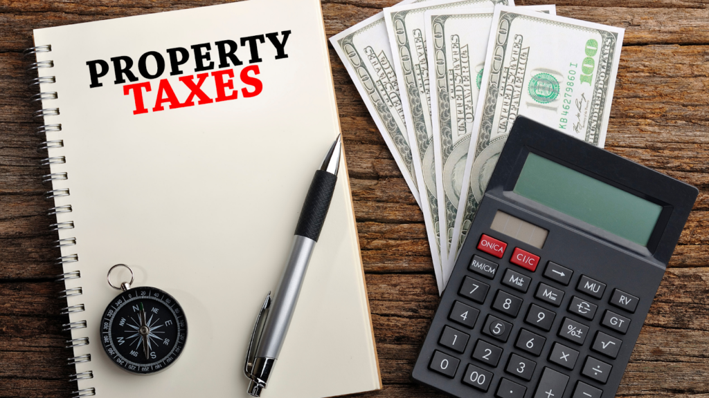 Property tax notebook with pen, cash, and calculator