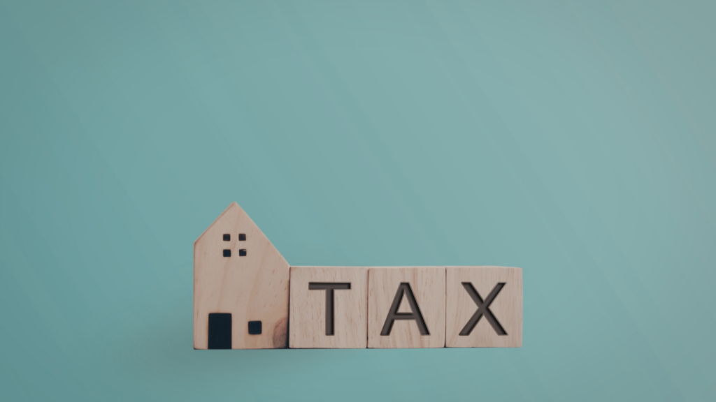 Property tax represented by wooden home and blocks