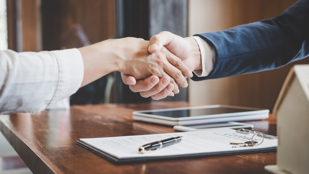 Tax professional and client seals the deal by shaking hands
