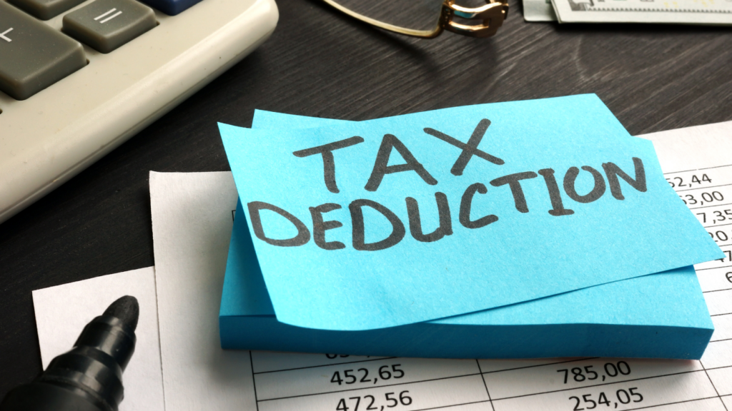 Tax deduction written on blue sticky note pad