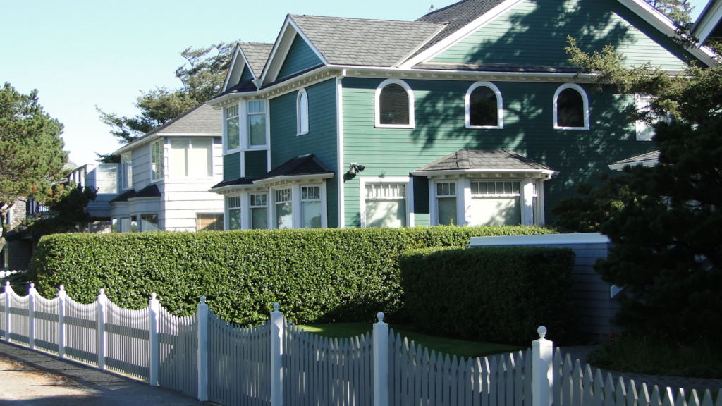 Neighboring properties with comparable white fences