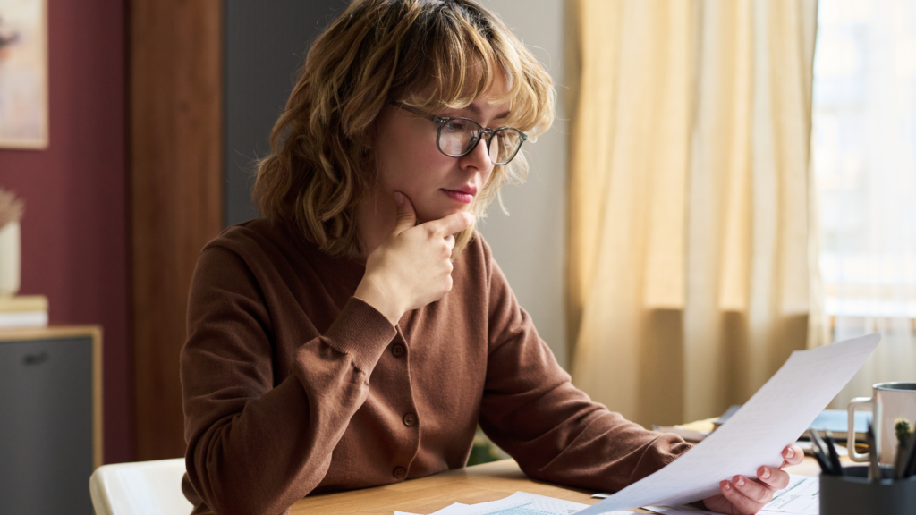 A woman carefully reviewing her property tax assessment documents