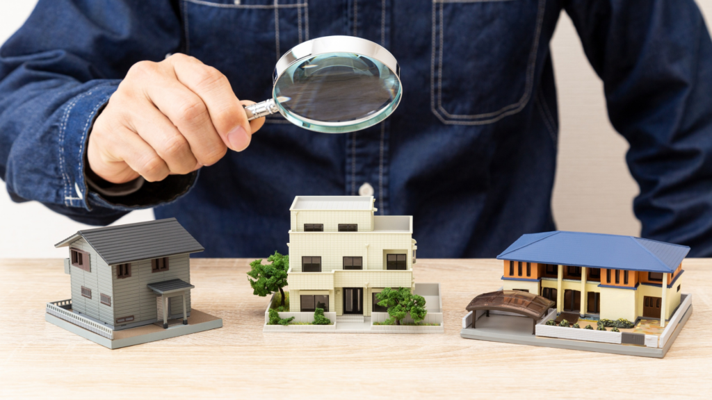 Appraiser reviewing multiple home models comparing assessed versus market value