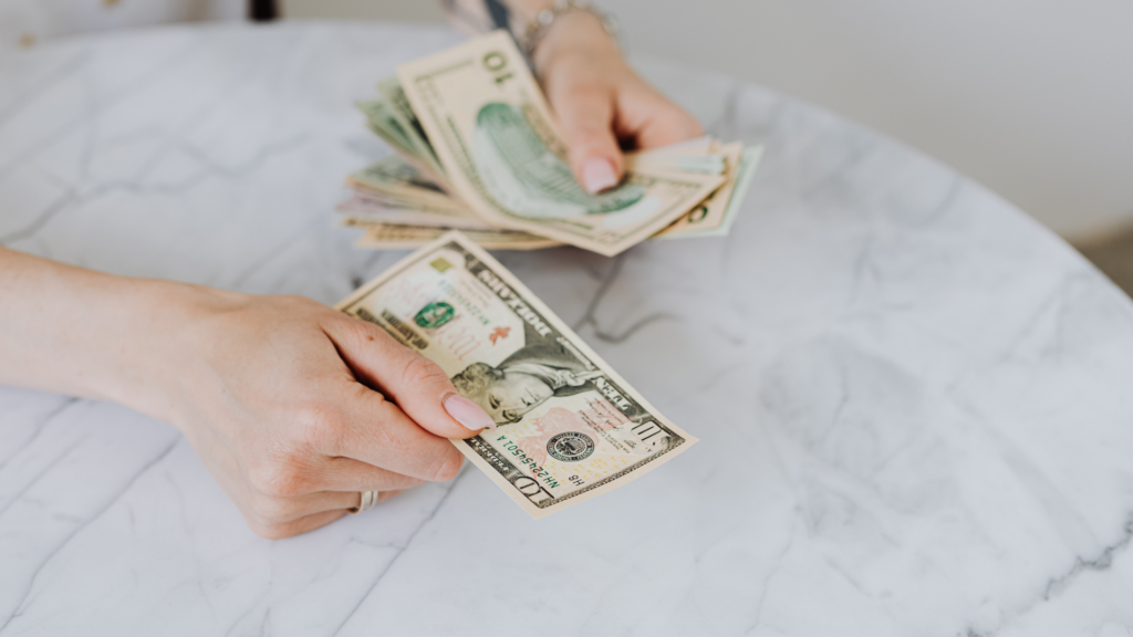 Homeowner handing over cash after a successful tax reduction