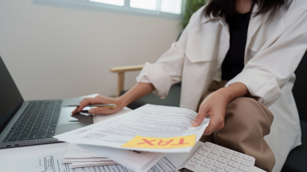 Homeowner organizing property tax documents and records at her desk