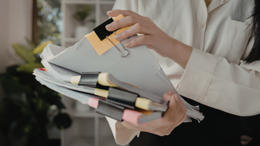 Homeowner sorting through home equity loan documents with colored binder clips