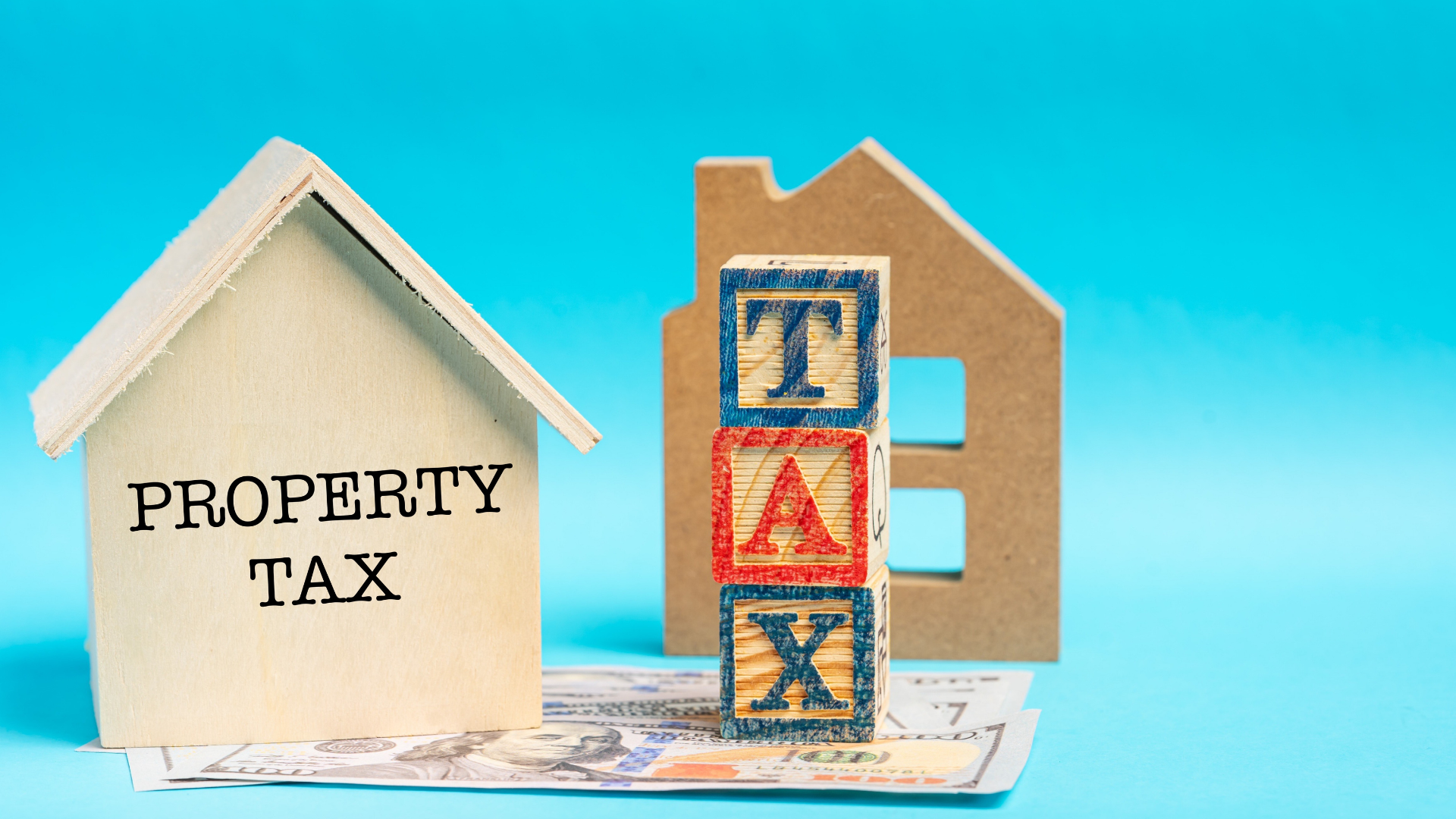 House models with cash illustrating how property taxes fund Illinois services