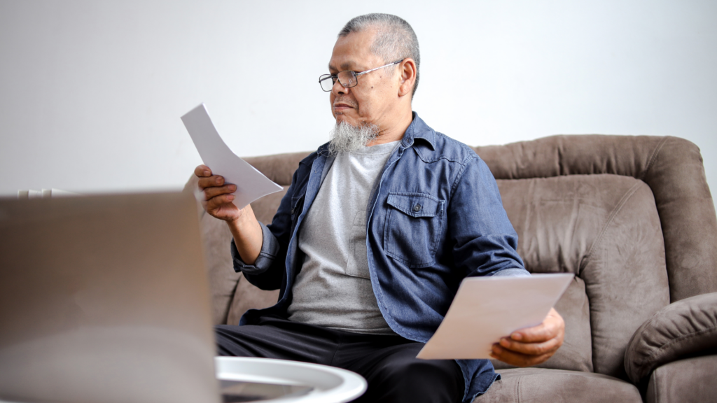 Senior homeowner examining legal documents for Cook County tax exemptions