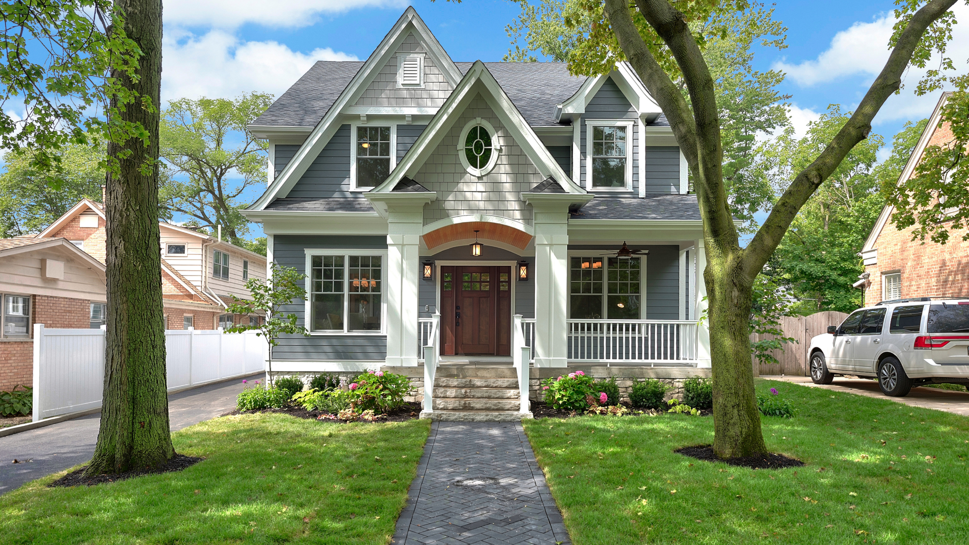 Suburban Illinois house with brick walkway and white porch railing