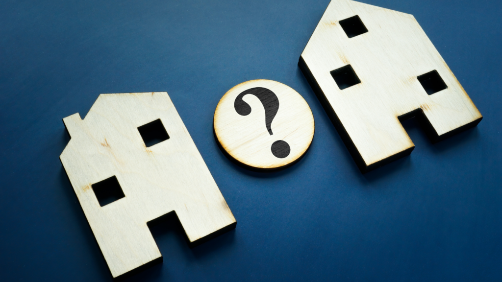 Two wooden houses with question mark comparing Illinois property taxes