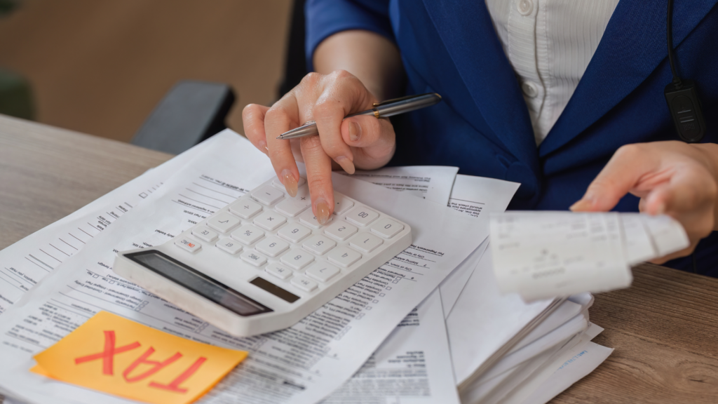 Reviewing assessed value appeal evidence with a calculator and tax form