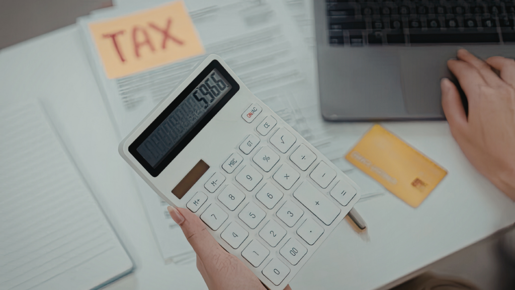 Tax documents and calculator representing property tax bill itemizing consideration