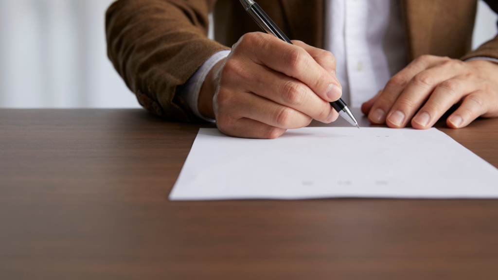 Close up of a professional drafting a formal written request