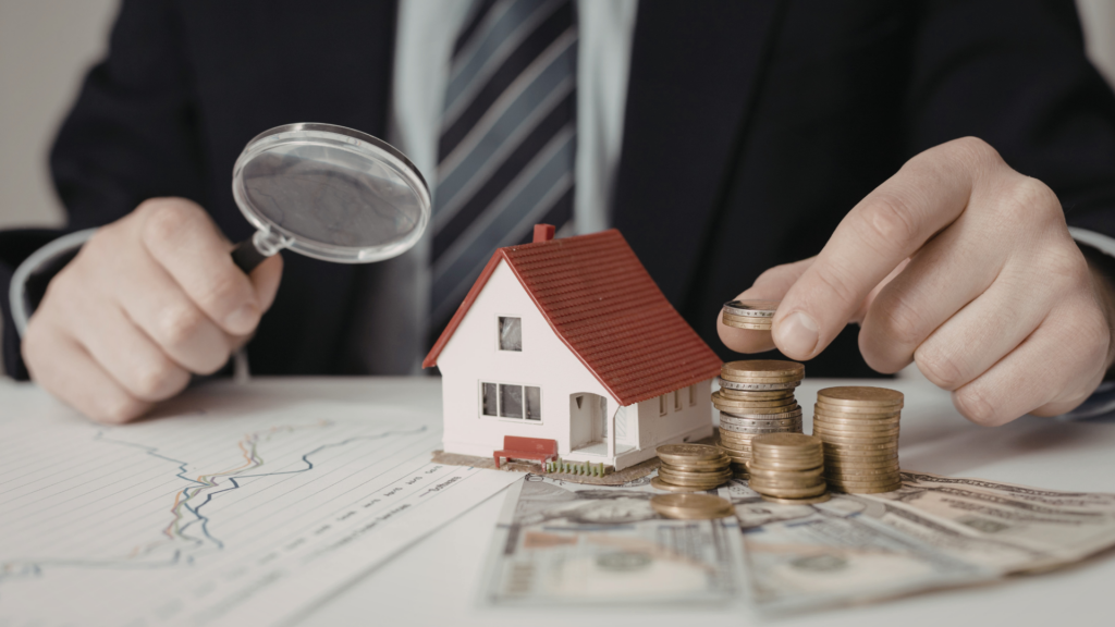 Professional reviewing inherited property value with coins and magnifying glass
