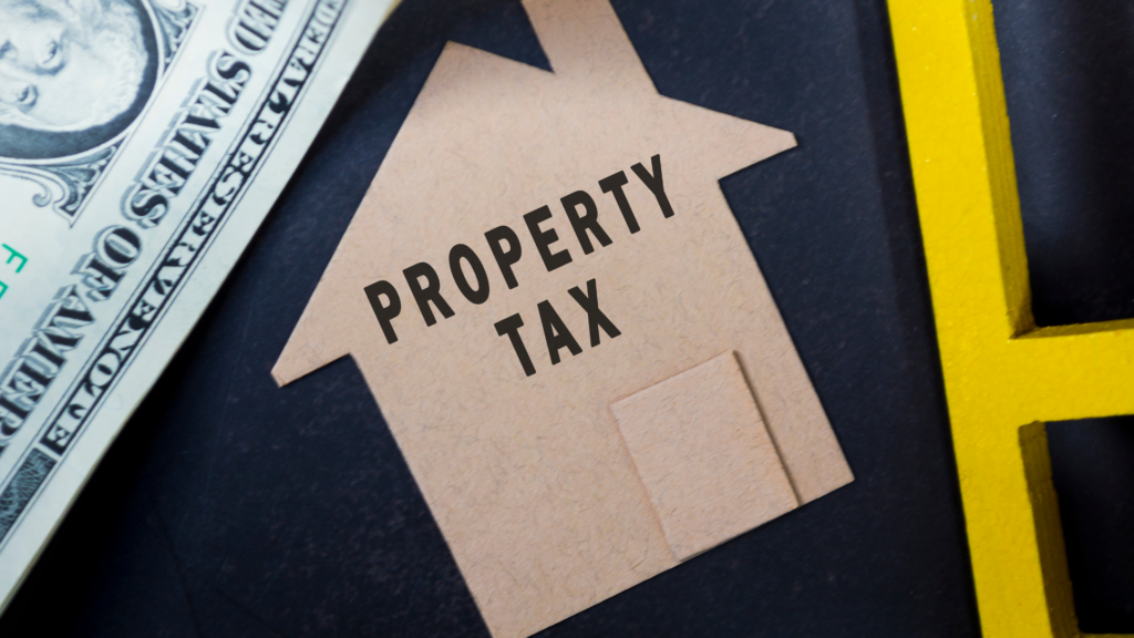 Property tax concept shown through a house cutout and U.S. currency