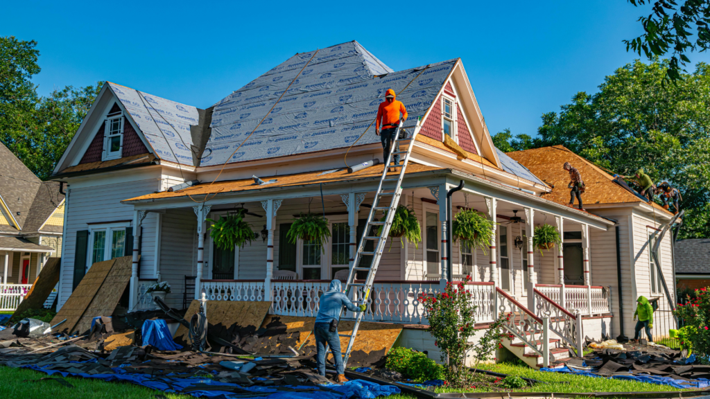 Roofing crew replacing damaged shingles on a Texas residential home