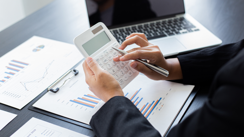 Tax professional using calculator to assess federal estate tax on property